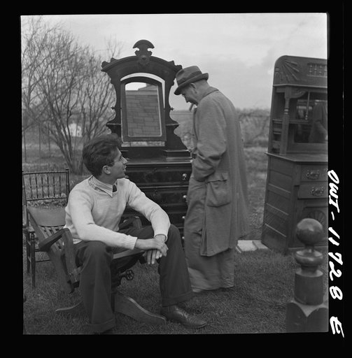 Untitled photo, possibly related to: Lititz, Pennsylvania. Looking over the furniture at a public sale before bidding
