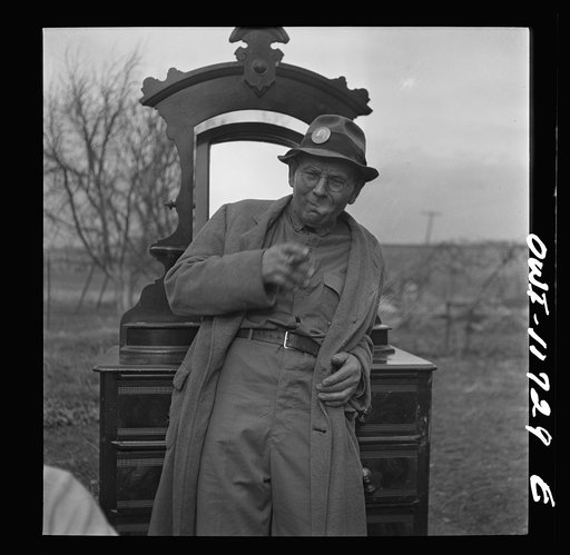 Untitled photo, possibly related to: Lititz, Pennsylvania. Looking over the furniture at a public sale before bidding