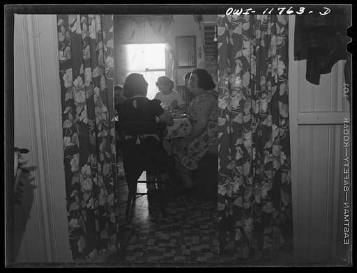Untitled photo, possibly related to: Lititz, Pennsylvania. Mrs. R.W. (Elizabeth) Almoney, forty-seven (center rear), has had eleven children. She works as a gauge inspector at the Animal Trap Company and on Sunday does the washing. Her husband (left) works in the local chocolate factory. Daughter Ar