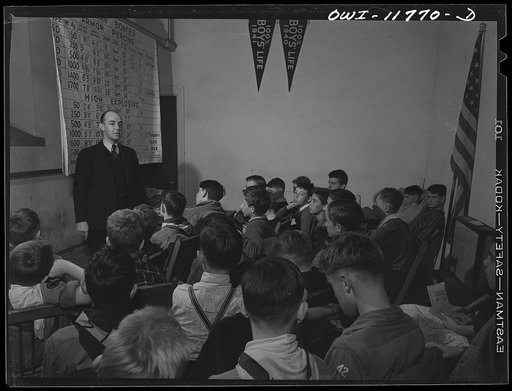 Untitled photo, possibly related to: Lititz, Pennsylvania. Raymond Runk, accountant at the Animal Trap Company and fire captain, giving a lecture on German bombs to Boy Scouts who are learning to be messengers. In emergencies, their duty would be to report fire bombs to the proper people