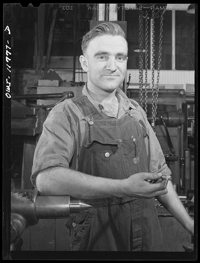 Lititz, Pennsylvania. Raymond Newswanger works a lathe in the Animal Trap Company machine shop. He's a Mennonite, about thirty, and hopes his church won't find out he's doing defense work. Most Mennonites are farmers, and Newswanger used to be