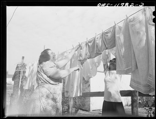 Lititz, Pennsylvania. Elizabeth Almoney, who has three sons and three brothers in the service, handing out her washing on Sunday with her daughter Geraldine whose husband is an Army truck driver