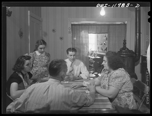 Lititz, Pennsylvania. The Almoney family playing cards. Left to right: Arline, Edna, Arline's boyfriend Elvin Hanley who is nineteen and will be drafted in January, Mrs. A., Mr. A (back to camera)