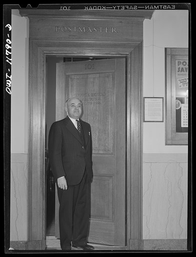 Untitled photo, possibly related to: Lititz, Pennsylvania. Postmaster Robert Pautz chatting with two friends in the post office. He has three sons, and one son-in-law in the service, and his daughter works in the U.S. War Department, so he has every reason to push the sale of war bonds. He plasters 
