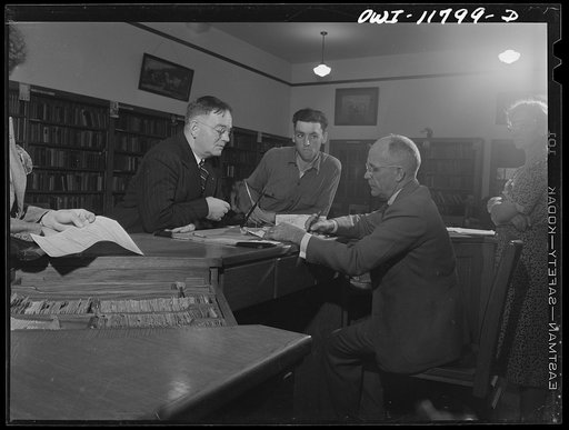 Lititz, Pennsylvania. Tire registration took place in the library of the schoolhouse, supervised by principal M.C. Demmy. Mr. Demmy is signing the papers of O.K. Bushong, the express agent