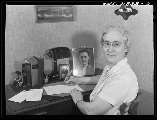 Lititz, Pennsylvania. Mrs. Viola Marvel in her apartment, writing a letter to her son in the U.S. Army. She works in the Animal Trap Company now, but worked in a Philadelphia department store before the war