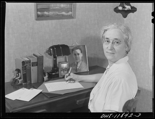Lititz, Pennsylvania. Mrs. Viola Marvel in her apartment, writing a letter to her son in the U.S. Army. She works in the Animal Trap Company now, but worked in Philadelphia department store before the war