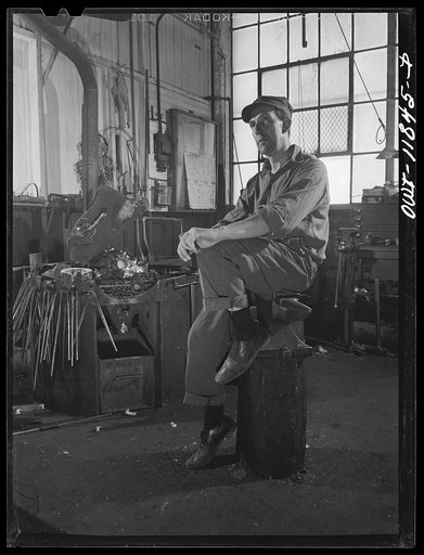 Lititz, Pennsylvania. Ellis Spickler has been working at the Animal Trap Company since 1909; he finds a blacksmith's forge the best way to harden and temper setting tools