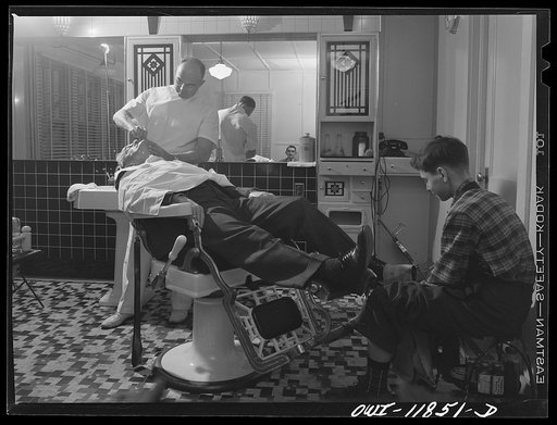 Lititz, Pennsylvania. Mr. Pennepacker, one of seven barbers in town, has sixty less haircuts a month since the boys left town