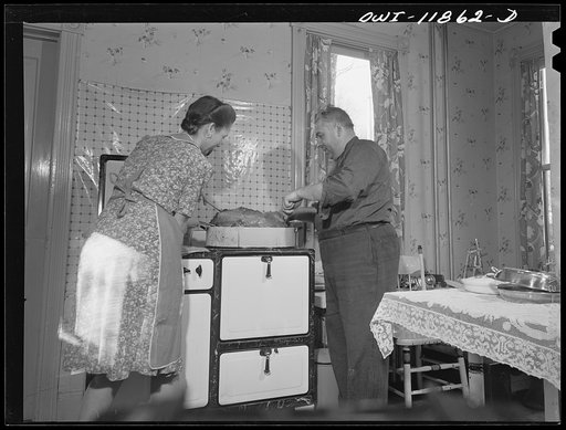 Untitled photo, possibly related to: Neffsville, Pennsylvania. Mr. and Mrs. Earle Landis turn over their Thanksgiving turkey