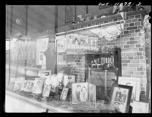 Lititz, Pennsylvania. Local photographer, the son of the general store owner, has a display in a window of his father's store. The second picture from the right is of Mrs. Julian Bachman and her husband in uniform before he left for Officers' Training School in Kentucky