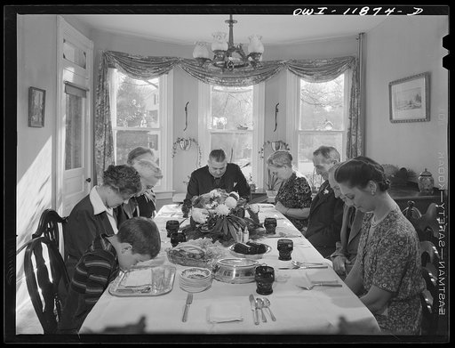 Neffsville, Pennsylvania. Saying grace before carving the turkey at Thanksgiving dinner in the home of Earle Landis