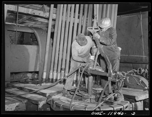 Andrews County, Texas. Pulling pipe out of well at night