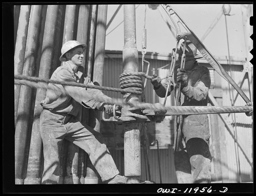Untitled photo, possibly related to: Andrews County, Texas. Attaching new bit to the drill pipe
