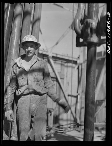 Untitled photo, possibly related to: Andrews County, Texas. Attaching new bit to the drill pipe