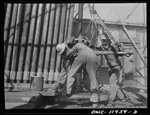 Untitled photo, possibly related to: Andrews County, Texas. Attaching new bit to the drill pipe