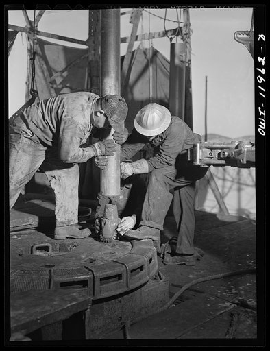 Andrews County, Texas. Attaching new bit to the drill pipe