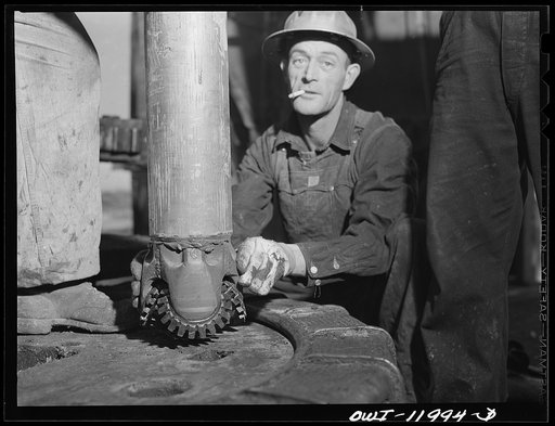 Untitled photo, possibly related to: Andrews County, Texas. Attaching new bit to the drill pipe