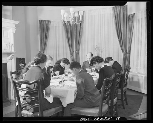 Washington, D.C. Dr. Mordica [i.e. Mordecai] Johnson, president of Howard University saying grace before Thanksgiving dinner