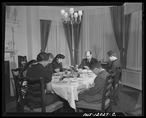 Washington, D.C. Dr. Mordica [i.e. Mordecai] Johnson, president of Howard University, saying grace before Thanksgiving dinner