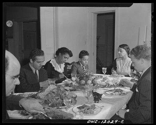 Untitled photo, possibly related to: Washington, D.C. Dr. Mordica [i.e. Mordecai] Johnson, president of Howard University, saying grace before Thanksgiving dinner