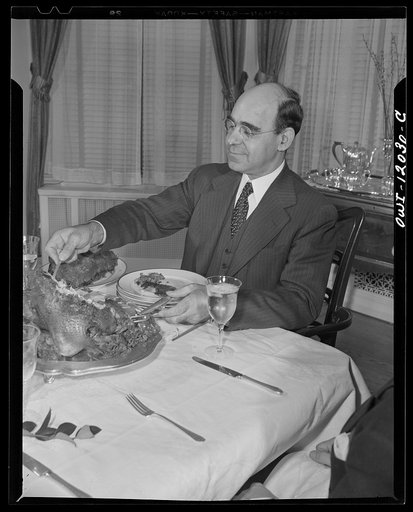 Washington, D.C. Dr. Mordica [i.e. Mordecai] Johnson, president of Howard University, serving portions of Thanksgiving turkey to members of his family