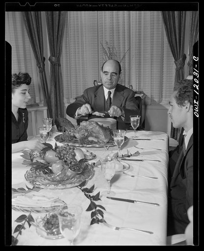 Washington, D.C. Dr. Mordica [i.e. Mordecai] Johnson, president of Howard University, serving portions of Thanksgiving turkey to members of his family