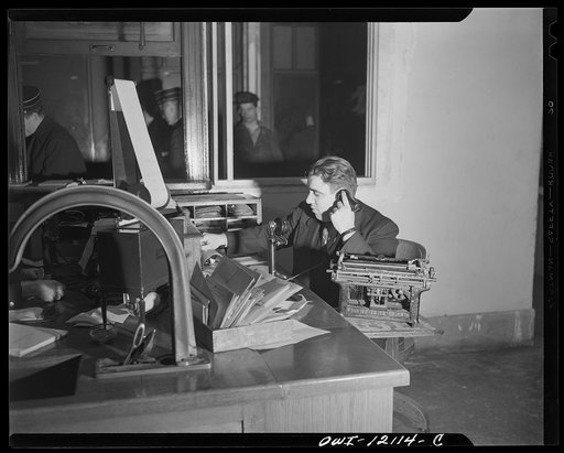 Washington, D.C. Clerk in the station master's office getting the last minute line-up on late trains before posting them for travelers at the Union Station
