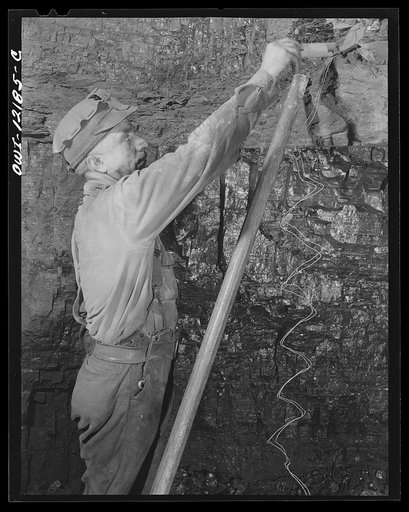 Pittsburgh, Pennsylvania (vicinity). Montour no. 4 mine of the Pittsburgh Coal Company. Miner putting powder charge into a face of coal which is to be "shot down"