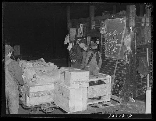 Chicago, Illinois. Workmen getting instructions at one of the offices of the freight house at a Chicago and Northwestern Railroad yard
