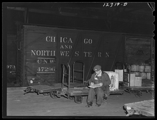 Chicago, Illinois. A checker getting his list ready for loading a car in the freight house of a Chicago and Northwestern Railroad yard