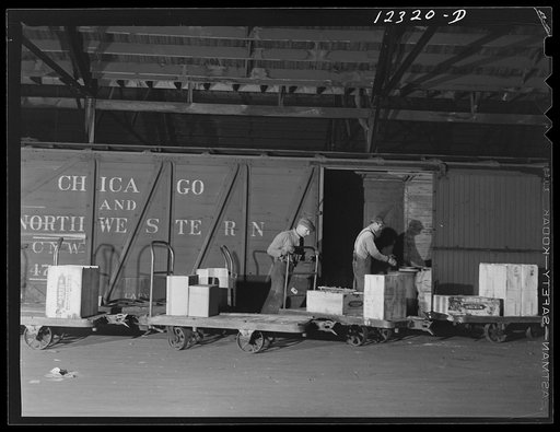 Chicago, Illinois. Loading a freight car in the freight house of a Chicago and Northwestern Railroad yard