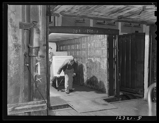 Chicago, Illinois. Unloading a truck for shipment of goods by rail in the freight house at a Chicago and Northwestern Railroad yard