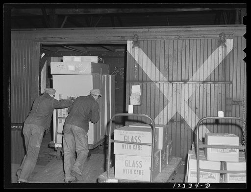 Chicago, Illinois. The Chicago and Northwestern Railroad runs a special service in these freight cars marked "X" between Chicago and Milwaukee. The cars are loaded with goods in proper order on these hand trucks. The cars are sent on to Milwaukee, trucks and all, are unloaded there, trucks reloaded,