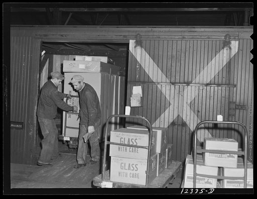Chicago, Illinois. The Chicago and Northwestern Railroad runs a special service in these freight cars marked "X" between Chicago and Milwaukee. The cars are loaded with goods in proper order on these hand trucks. The cars are sent on to Milwaukee, trucks and all, are unloaded there, trucks reloaded,