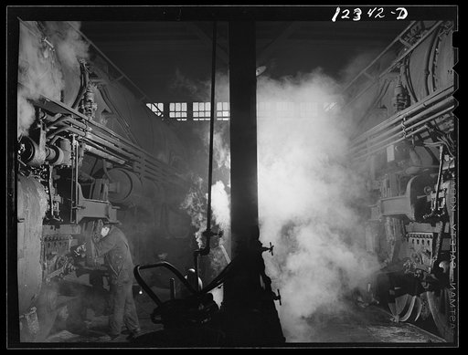 Chicago, Illinois. Servicing an engine at the roundhouse at a Chicago and Northwestern Railroad yard