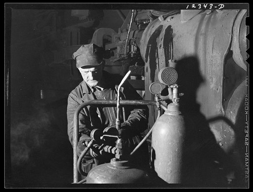 Chicago, Illinois. A welder getting ready for work at the roundhouse at a Chicago and Northwestern Railroad yard