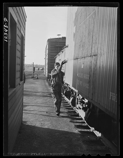 Chicago, Illinois. Hamp worker uncoupling cars as they reach the top of the hump at a Chicago and Northwestern Railroad yard