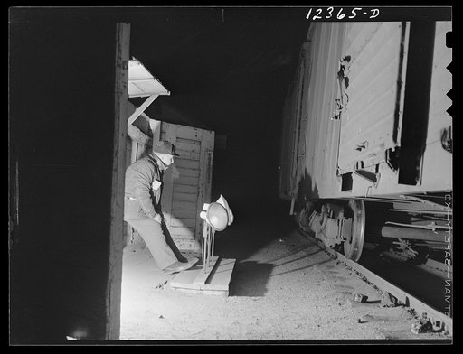 Chicago, Illinois. Car inspector working at night at the hump at a Chicago and Northwestern Railroad yard