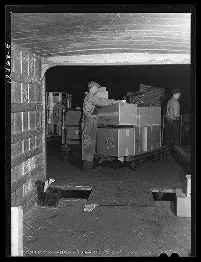 Chicago, Illinois. Loading goods into a truck trailer at a freight house at a Chicago and Northwestern Railroad yard