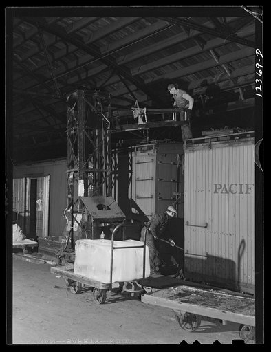 Chicago, Illinois. Icing a refrigerator car in the freight house at a Chicago and Northwestern Railroad yard