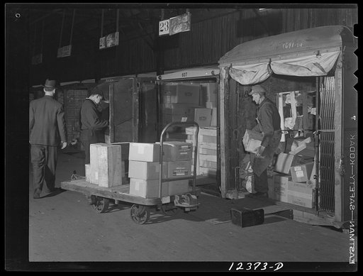 Chicago, Illinois. Unloading truck trailers in the freight house at a Chicago and Northwestern Railroad yard