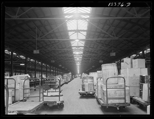 Chicago, Illinois. Goods of every description lined up on loading platforms at a freight house at the Chicago and Northwestern Railroad yard