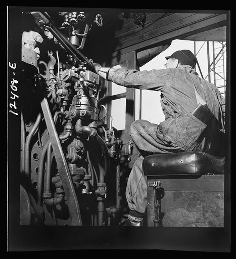 Untitled photo, possibly related to: Chicago, Illinois. Engineer of a locomotive waiting to make his run to Clinton, Iowa from a Chicago and Northwestern Railroad yard