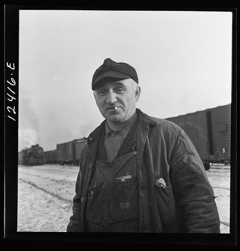 Chicago, Illinois. Railroad worker whose job is to inspect journal boxes, brake shoes, etc. and make minor repairs at a Chicago and Northwestern Railroad yard
