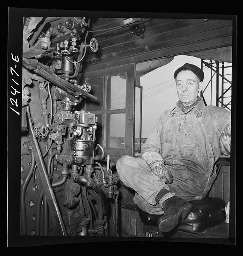 Chicago, Illinois. Engineer of a locomotive waiting to make his run to Clinton, Iowa from a Chicago and Northwestern Railroad yard