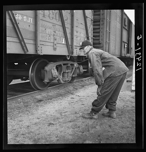 Chicago, Illinois. Inspector watching the cars as they go over the hump at a Chicago and Northwestern Railroad yard