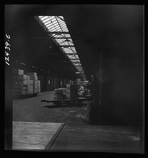 Untitled photo, possibly related to: Chicago, Illinois. Goods of every description on loading platforms in a yard waiting to be loaded into cars at the Chicago and Northwestern Railroad freight house