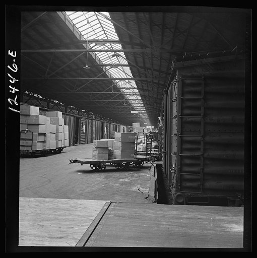 Untitled photo, possibly related to: Chicago, Illinois. Goods of every description on loading platforms in a yard waiting to be loaded into cars at the Chicago and Northwestern Railroad freight house