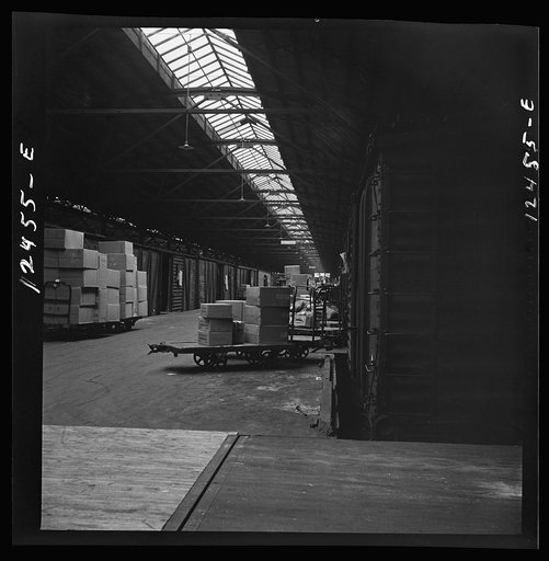 Untitled photo, possibly related to: Chicago, Illinois. Goods of every description on loading platforms in a yard waiting to be loaded into cars at the Chicago and Northwestern Railroad freight house